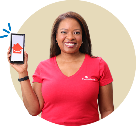 HomeServe technician in a red shirt flexing his bicep and looking strong